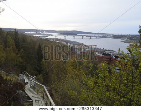 A Wooden Hiking Path On The Mountain In Sundsvall. A Lot Of Trees Are Visible And In The Background 