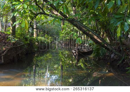 Flooded Traditional Boat Of Kerala Backwaters Moored To The Shore. Backwaters In Kerala Is A Network