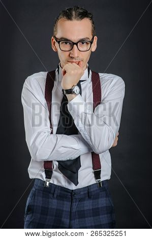 Young Handsome Boy In White Shirt With Tie And Glases, Clock On Hand,
With Black Background