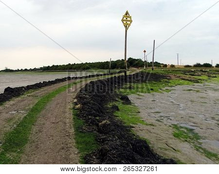 A Landscape View Of A Causeway Across A Estuary Leading To Northey Island In Essex At Low Tide With 