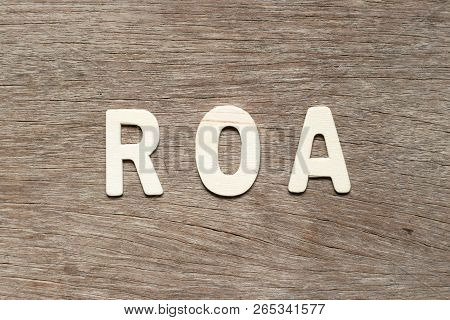 Alphabet Letter In Word Roa (abbbreviation Of Return On Assets) On Wood Background