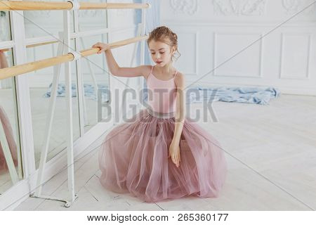 Young Classical Ballet Dancer Girl In Dance Class. Beautiful Graceful Ballerina Practice Ballet Posi