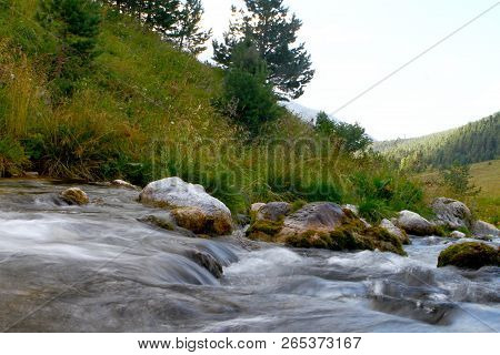 Photo Of Nature - Spring Water Mountain River Shot With Long Exposure And The Wonderful Petrous Cree