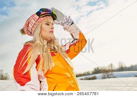 Picture of happy young lady snowboarder 