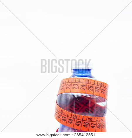 Bottle Of Water And Red Measure Tape