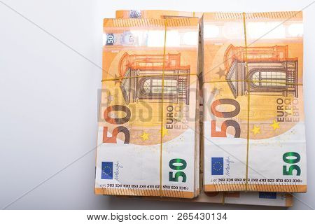Pile Of 50 Real Euro Notes 50-euro Banknotes Under Rubber Band Isolated On White. About 20000 Euros 