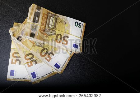Pile Of 50 Real Euro Notes 50-euro Banknotes Under Rubber Band Isolated On Black. About 20000 Euros 