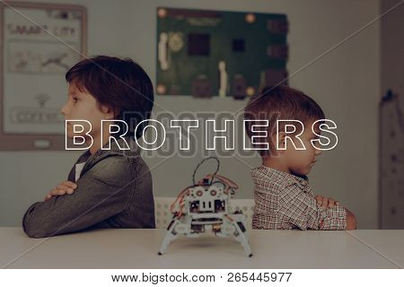Two Brothers. Back To Back. Grey Robot On The Table. Innovation Technology. Smart Kids. Holiday Leis