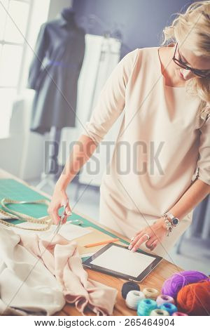 Fashion Designer Woman Working On Her Designs In The Studio.