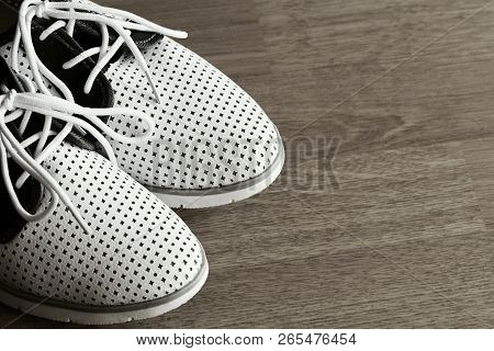 Pair Of Swhite Shoes On Wooden Background