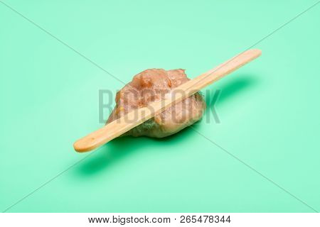 The Last Bit Of A Green Bean Popsicle On A Light Green Background
