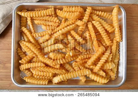 Overhead View Of Fresh Baked Crinkle Cut French Fries In A Baking Pan