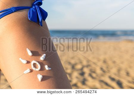 Sunscreen Suntan Cream. Sun Drawing. Sunblock Cream On Tanned Skin Closeup. Concept For Uv Rays Prot