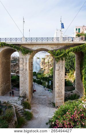 Polignano A Mare, Italy - July 6 2018: People On The Ponte Lama Monachile Bridge, Adriatic Sea, Apul