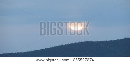 Sunset In Cloudy Sky Over Forested Hills. Bright Sunrise Landscape. Delicate Colors Of Early Morning