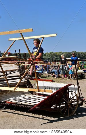 Pekin, North Dakota, September 2, 2018: An Unidentified  Young Man Rides An Old Mccormick Deering Gr