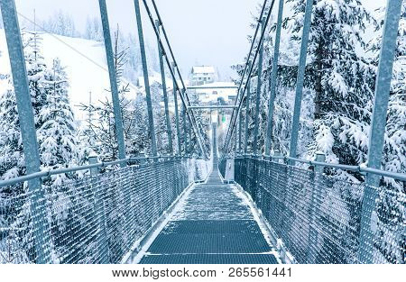 Pedestrian Suspension Bridge In Sattel Lucerne Region Switzerland. Winter Landscape.