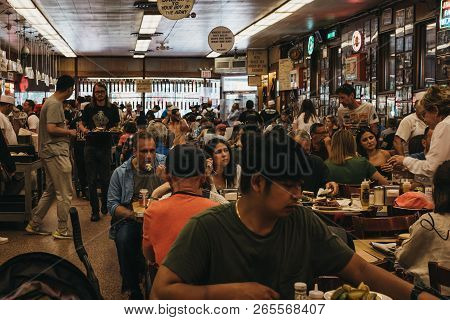 New York, Usa - May 29, 2018: Customers Sitting At The Tables, Eating Inside Katzs Deli In New York,