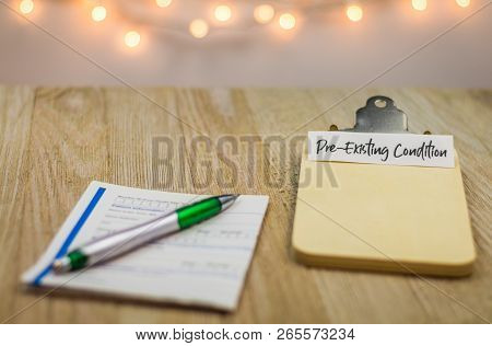 Pre-existing Condition Healthcare, Medical Forms Concept On Wooden Board With Paperwork And Clipboar