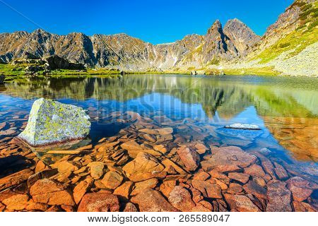 Amazing High Mountains Landscape, Blue Sky And Clean Alpine Lake With Colorful Stones, Lake Taul Por