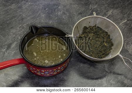 Cooking Of Marijuana Green Butter In Hot Water In Kitchen