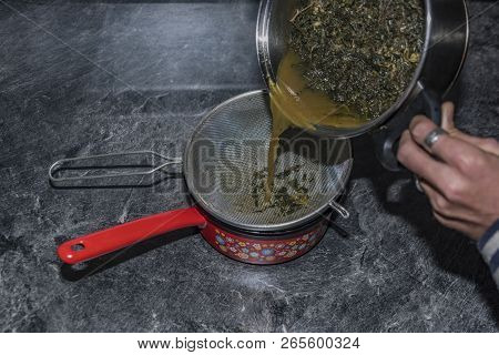 Cooking Of Marijuana Green Butter In Hot Water In Kitchen