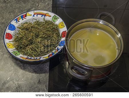 Cooking Of Marijuana Green Butter In Hot Water In Kitchen