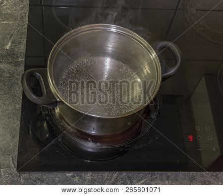 Cooking Of Marijuana Green Butter In Hot Water In Kitchen