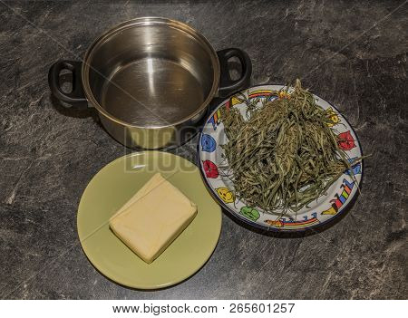 Cooking Of Marijuana Green Butter In Hot Water In Kitchen
