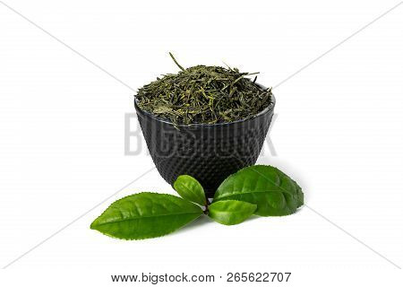 Green Sencha Tea In Black Cast Iron Cup With Tealeaves In Front Isolated On White Background.