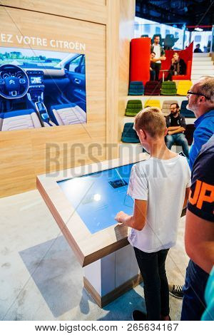 Paris, France - Oct 4, 2018: Father And Son Building On Digital Computer Simulator Screen Their New 