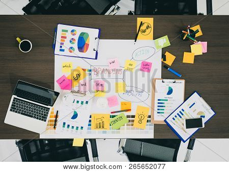 Top View Of Creative Designer Brainstorming Ducument On Wood Table In Meeting Room