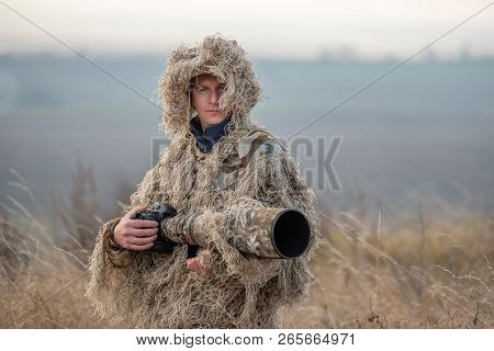 Wildlife Photographer In The Ghillie Suit Working