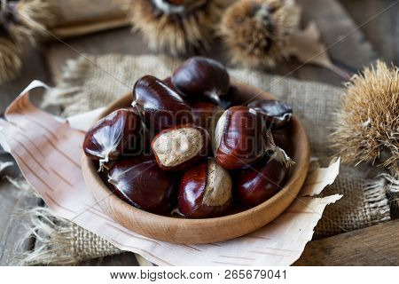 Roasted Chestnuts  Rustic Wooden Board Background, Selective Focus, Roasted Chestnuts . Roasted Ches