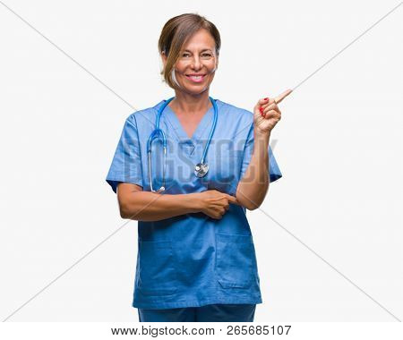 Middle age senior nurse doctor woman over isolated background with a big smile on face, pointing with hand and finger to the side looking at the camera.