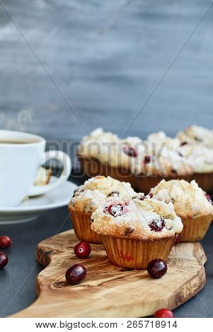 Cranberry Muffins On A Wood Cutting Board With More Cooling On A Bakers Rack. Extreme Shallow Depth 