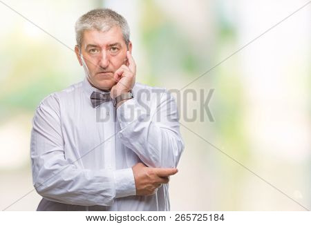 Handsome senior man wearing bow tie over isolated background thinking looking tired and bored with depression problems with crossed arms.