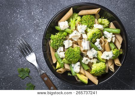 Whole-grain Pasta Penne With Broccoli, Avocado, Green Beans, Peas And Dorblu Cheese. Top View With C