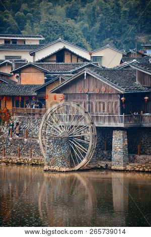 FUJIAN, CHINA â MARCH 2, 2018: Yunshuiyao old town by the river with watermill in Fujian, China.