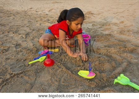 Little Girl Trying To Make A Fort With Sand On Alibag Beach, India
