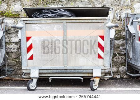 Dump Garbage Bin On Street  Near Concret Wall For Waste In Europe