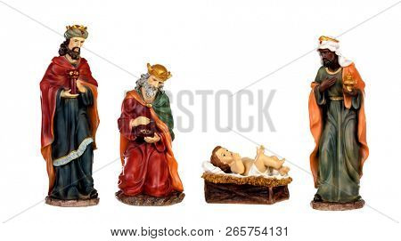 The three wise men and baby Jesus. Ceramic figures isolated on white background