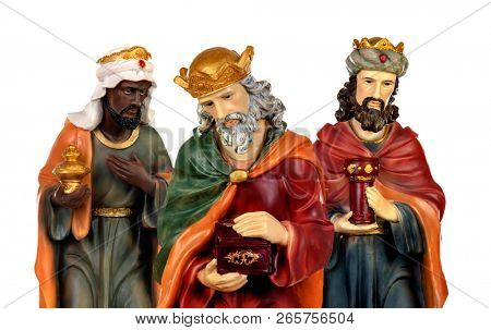 The three wise men and baby Jesus. Ceramic figures isolated on white background