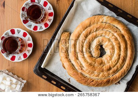 Turkish Tepsi Boregi / Round Borek In Tray With Tea.