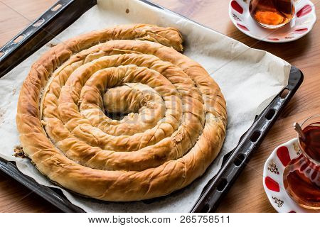 Turkish Tepsi Boregi / Round Borek In Tray With Tea.