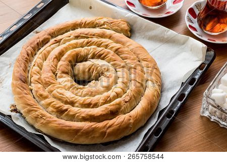 Turkish Tepsi Boregi / Round Borek In Tray With Tea.