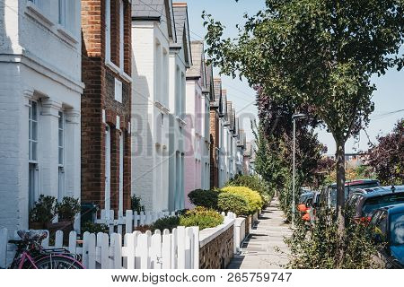 Cars Parked By Colourful Pastel Houses In Barnes, London. Barnes Is An Affluent Residential Area Of 
