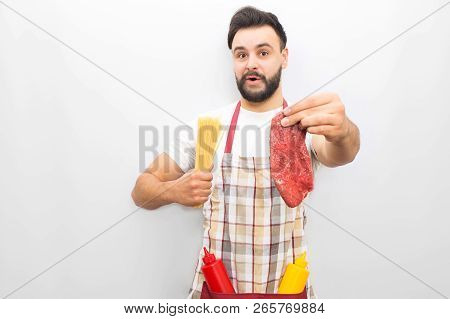 Bearded Chief Stands And Wonders. He Has Piece Of Steak In One Hand And Spagetti In Another One. You