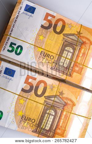Pile Of 50 Real Euro Notes 50-euro Banknotes Under Rubber Band Isolated On White. About 20000 Euros 