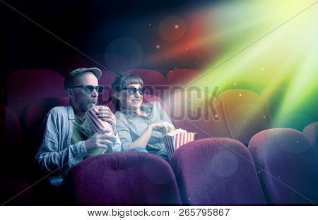 Teenager couple cuddling and watching the climax part of the movie